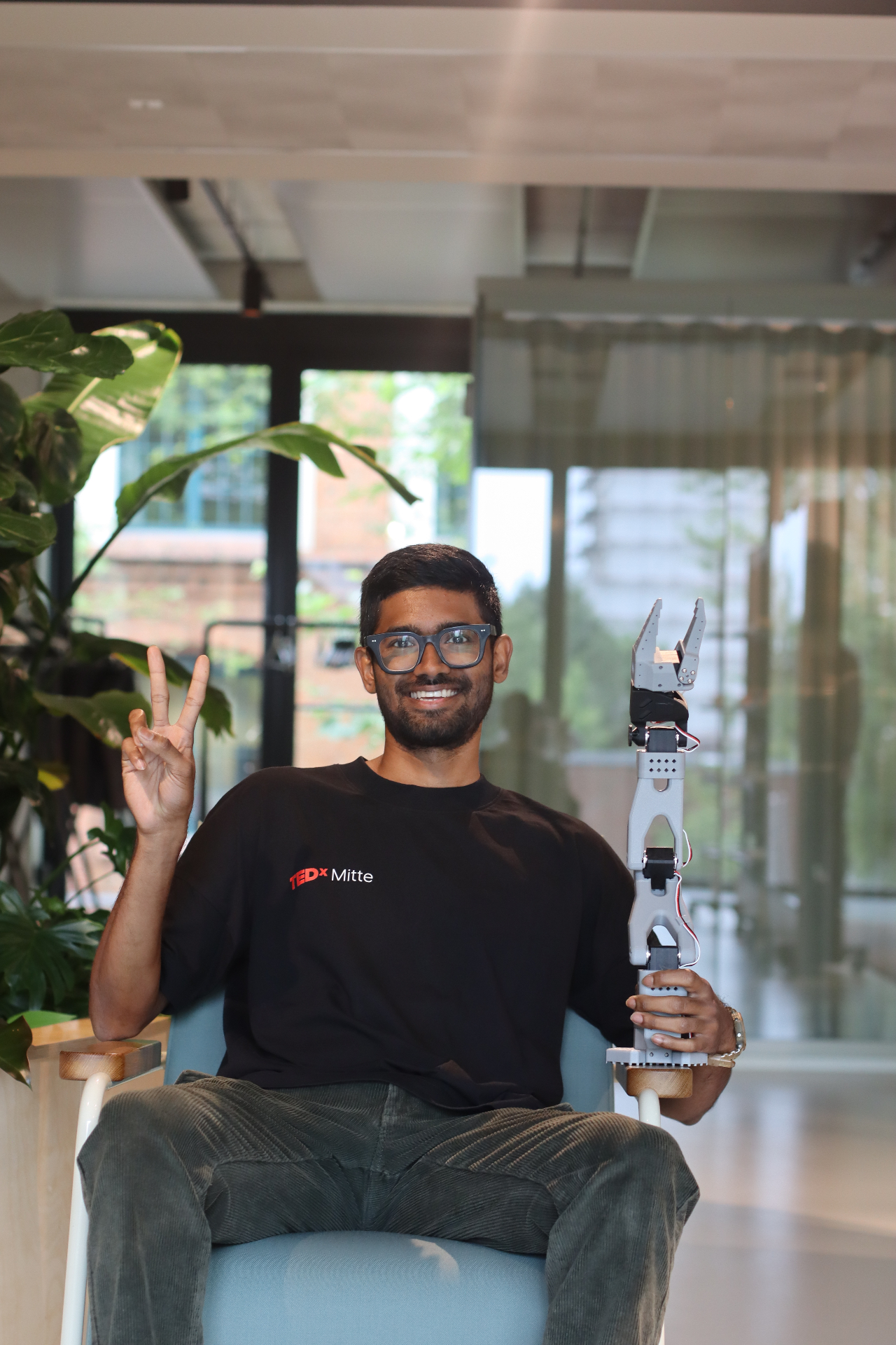 Vishal, co-founder of PROJECT//ORBIT, holding a robotic arm